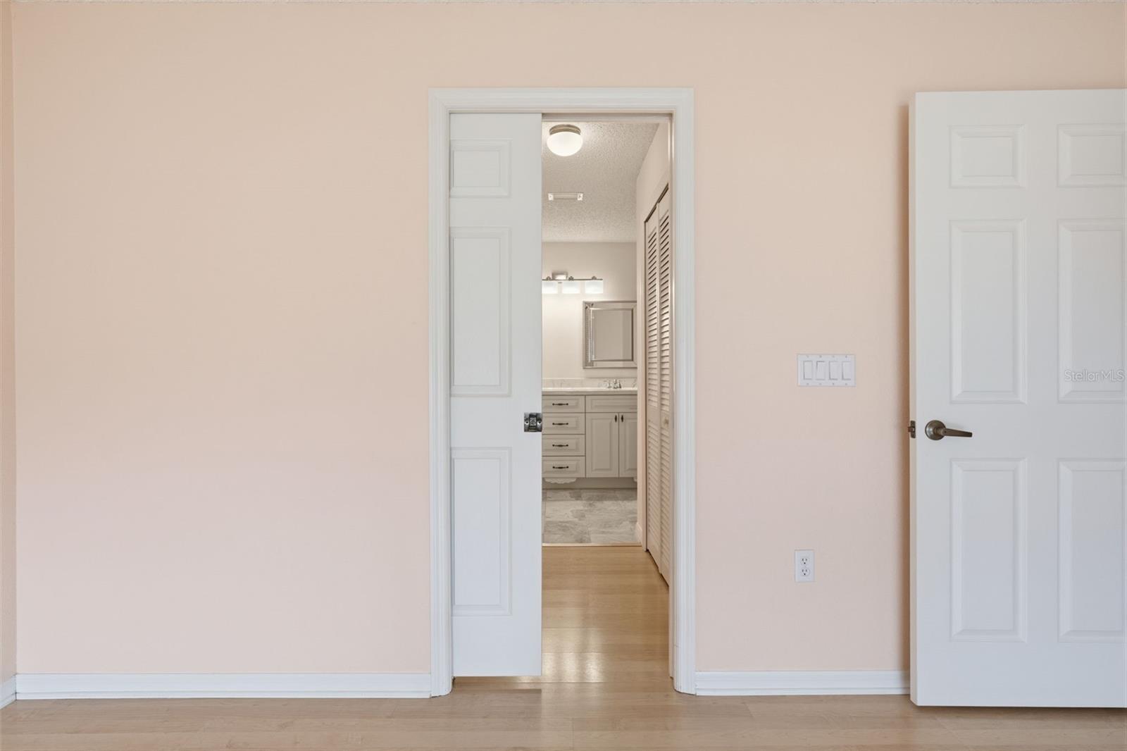 Convenient space-saving pocket door between bedroom and bathroom.