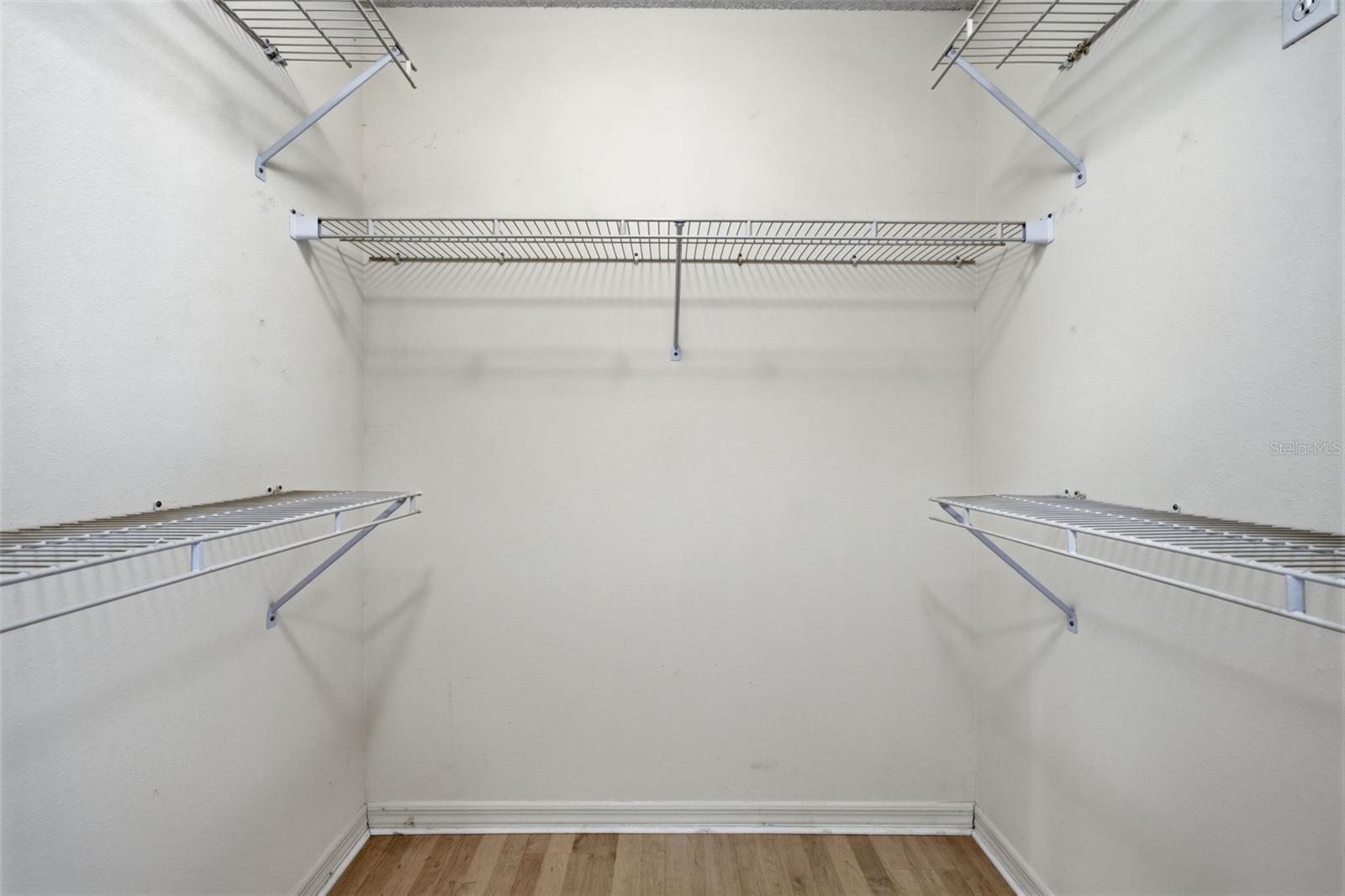 One of two equal-size walk-in closets in Primary bedroom.
