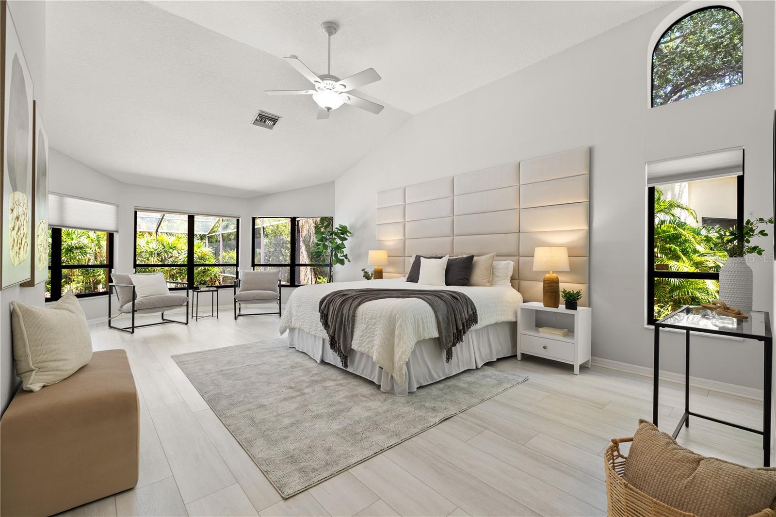 Large primary bedroom with sitting area and pool access