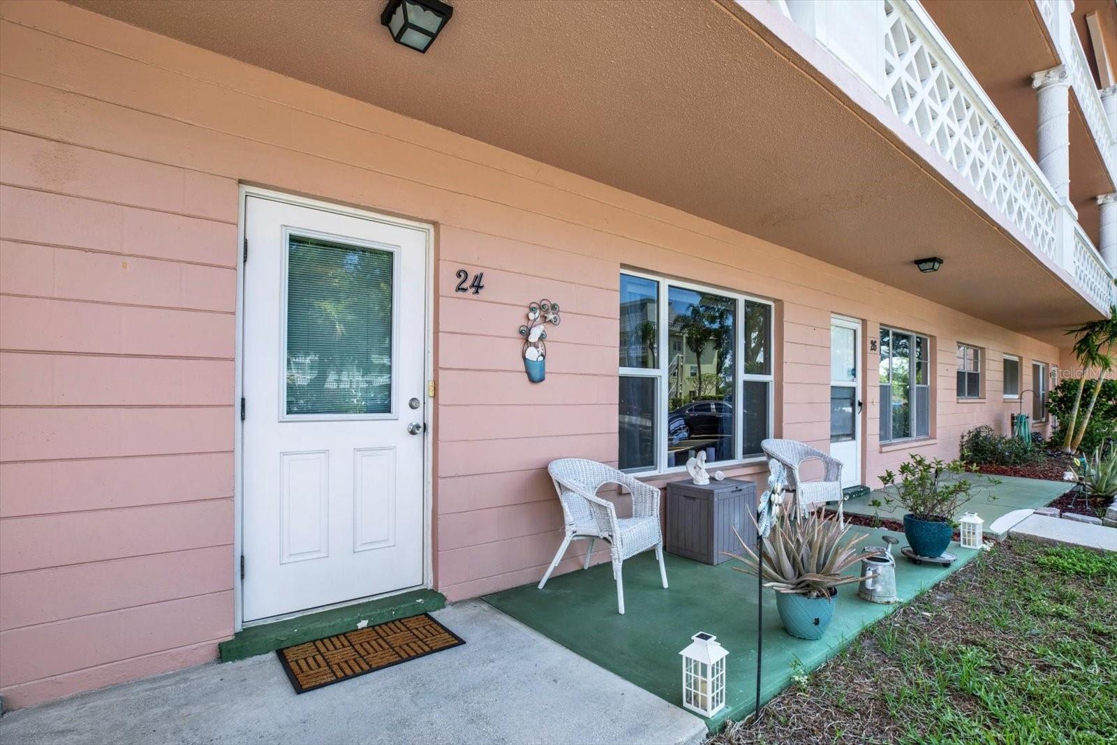 Ground-floor unit with covered front patio and seating space