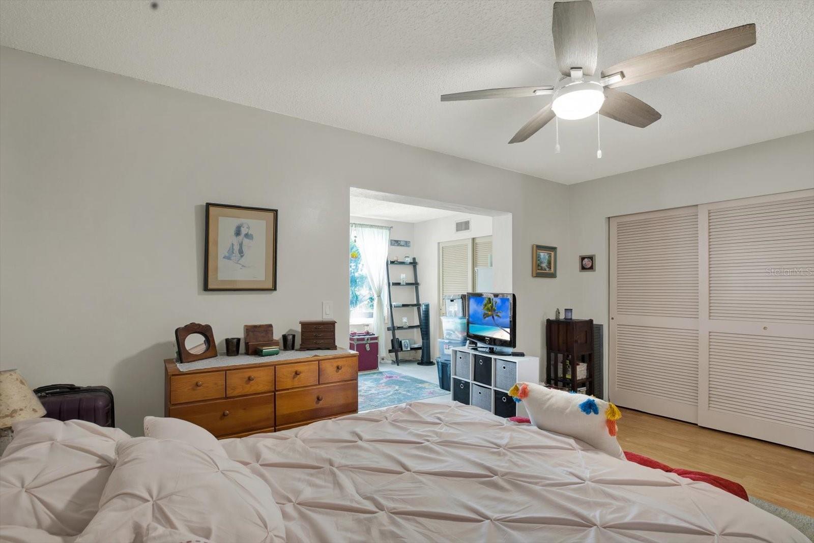 Primary bedroom with wood-look vinyl floors and closet