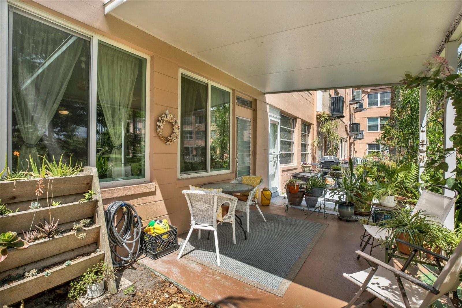 Private covered patio with tropical garden views.