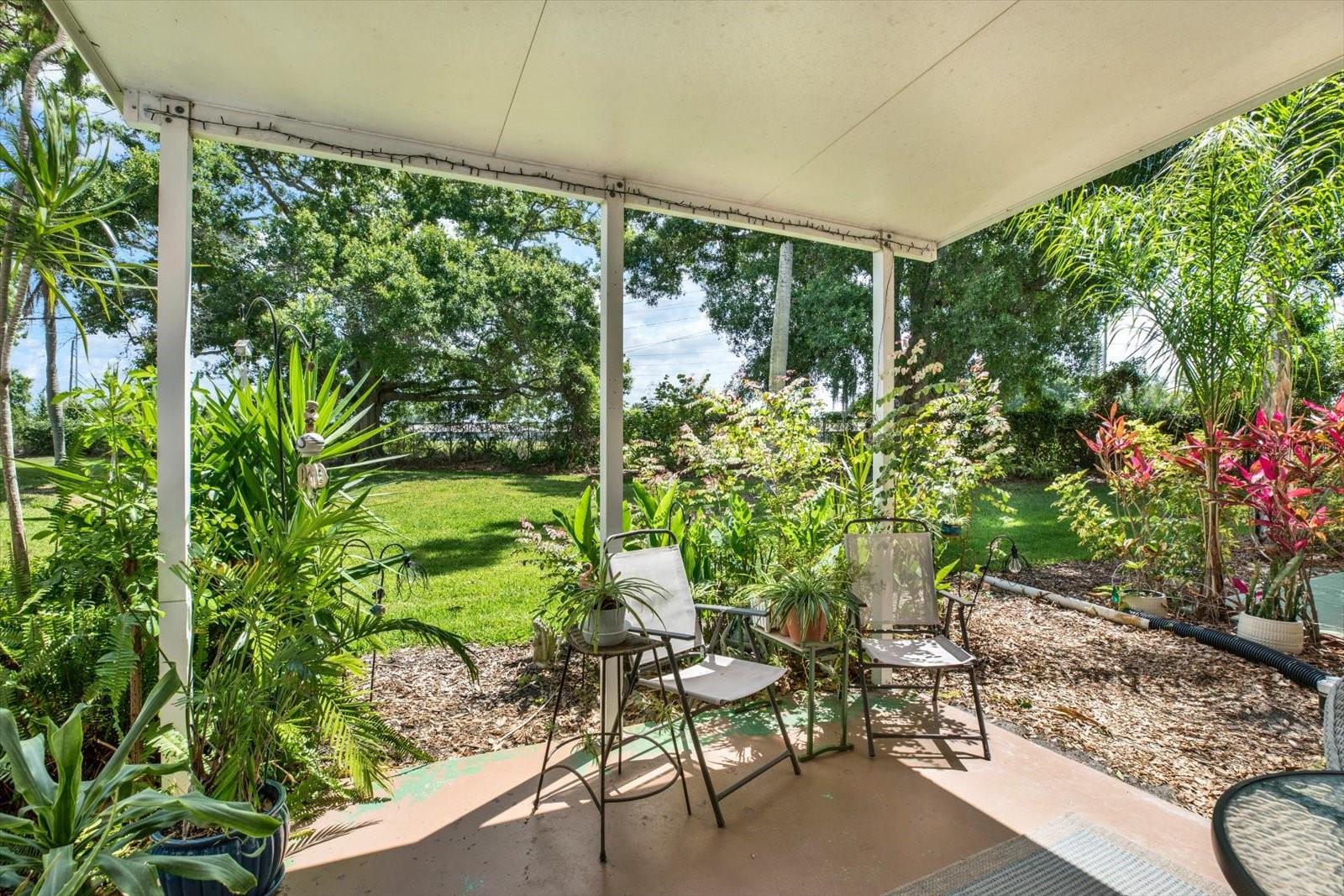 Covered rear patio with outdoor seating