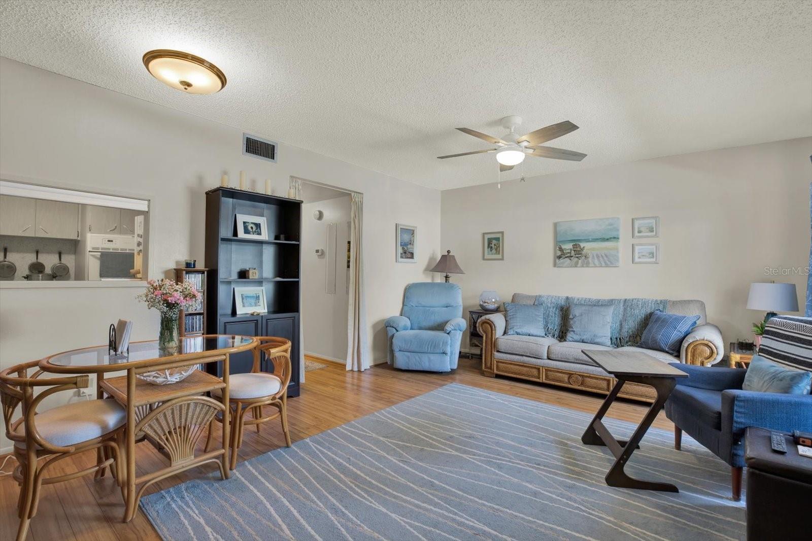 Open living and dining area with kitchen pass-through.