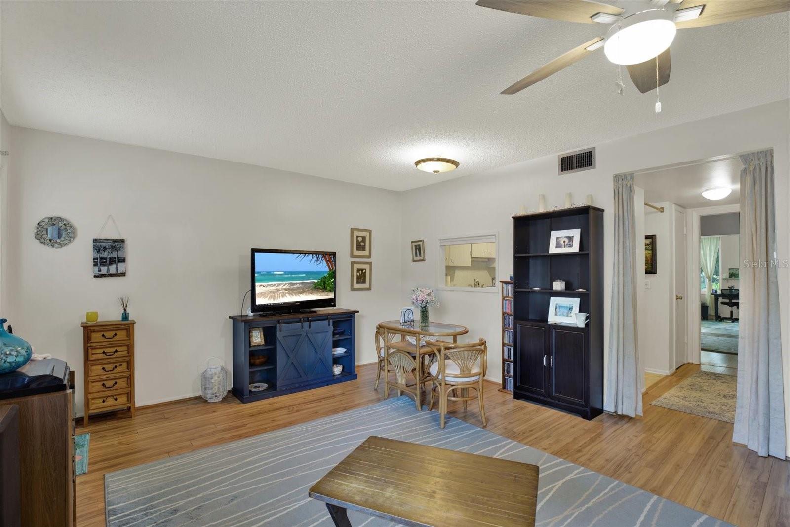 Open living and dining area with kitchen pass-through.