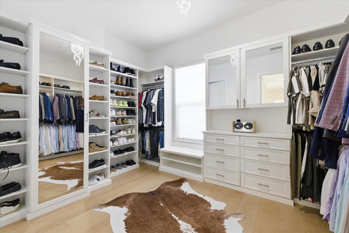 Primary Walk In Closet with Custom Built Ins