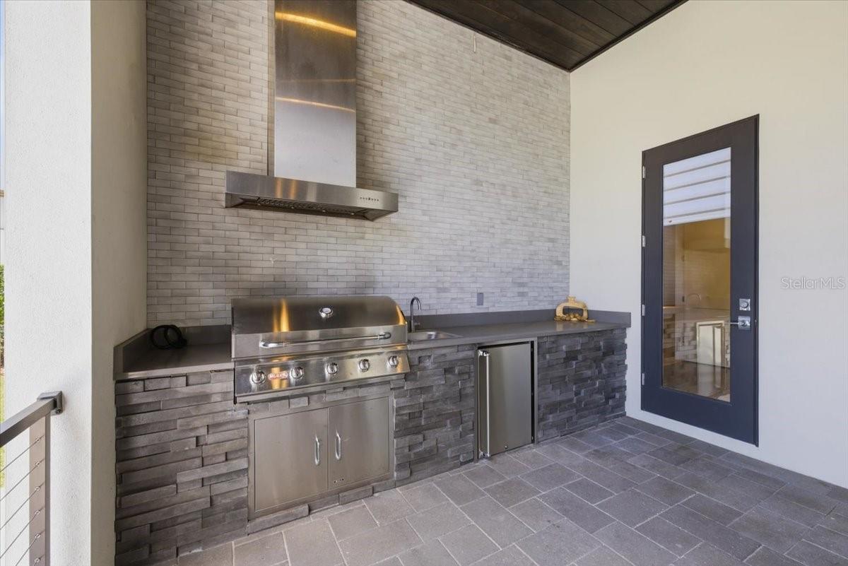 Summer Outdoor Kitchen Connected to Pool Bath