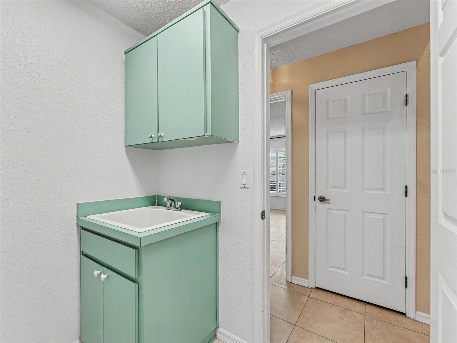 Utility Room w/a built in laundry sink and cabinets