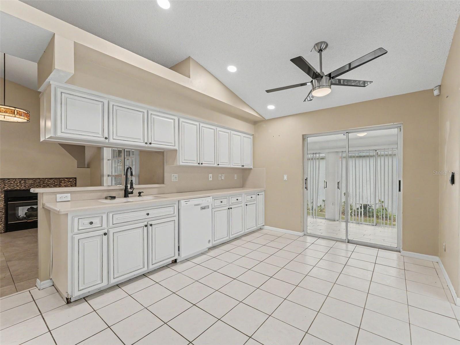 Kitchen w/sliders to the enclosed patio