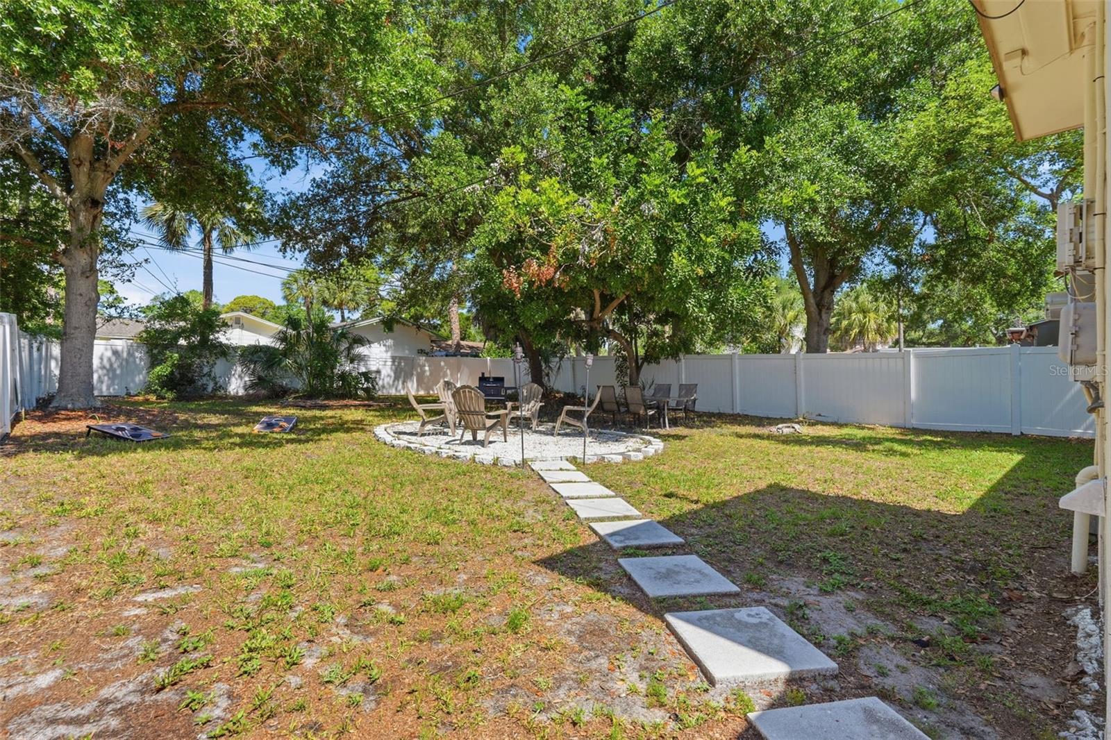Huge spacious backyard with firepit area and shaded trees