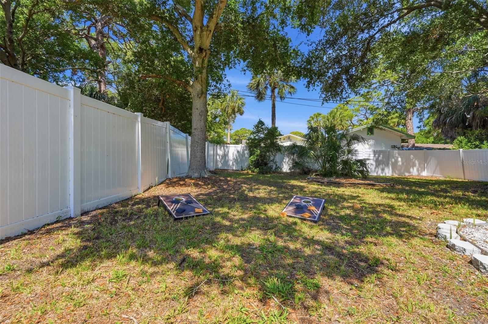 Huge spacious backyard with firepit area and shaded trees