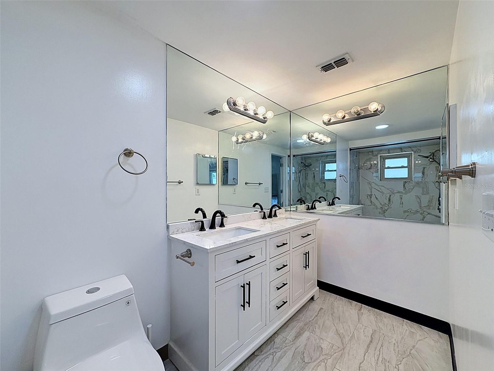 Large primary bath with generous storage and counter space.