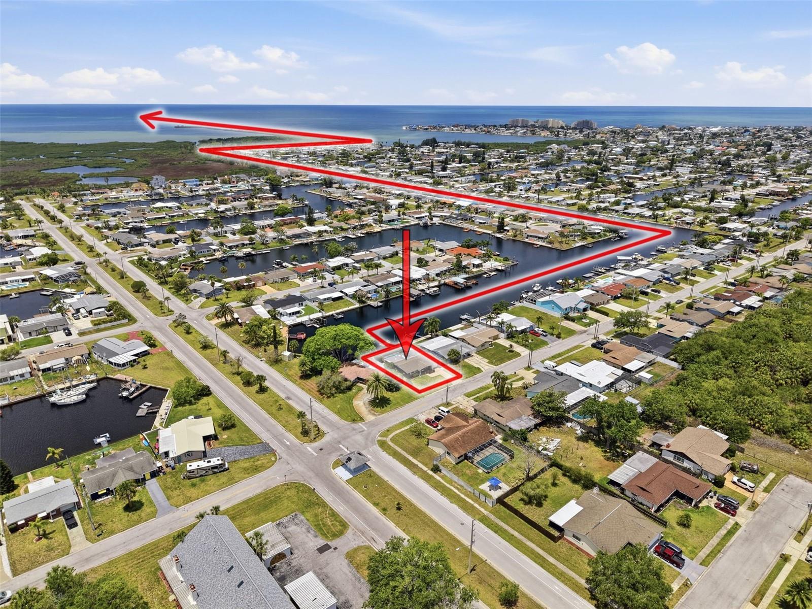 Aerial view highlights the direct Gulf access route from the property.