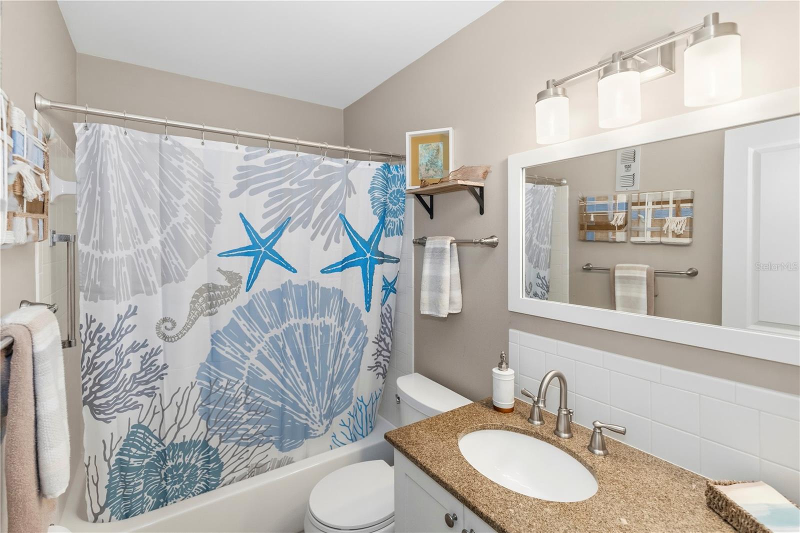 Updated guest bathroom has a shower/tub combo