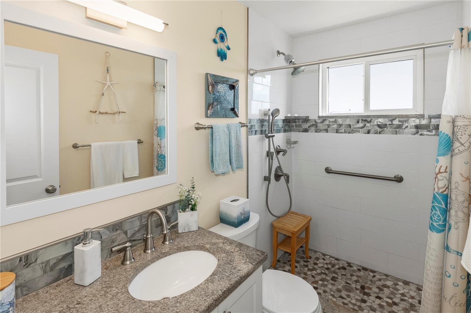 Primary bathroom has an updated walk in shower