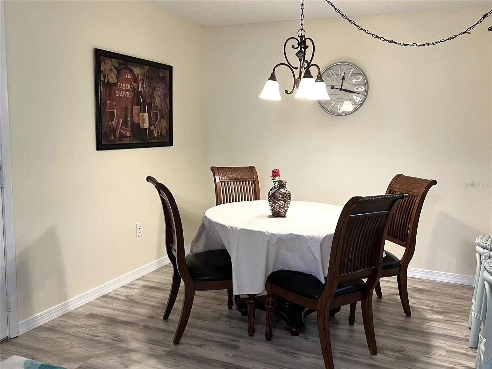 GLASS TOPPED DINING ROOM TABLE