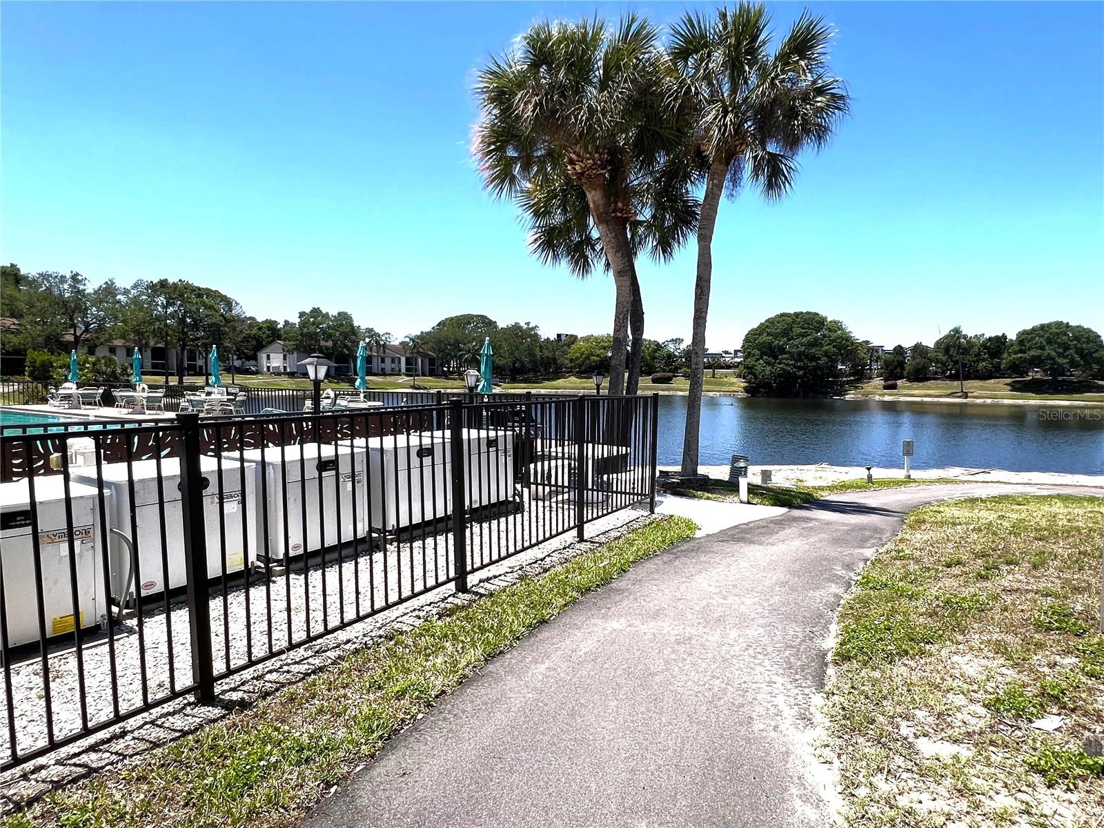 WALKING PATH AROUND POOL AT FRONT OF COMPLEX