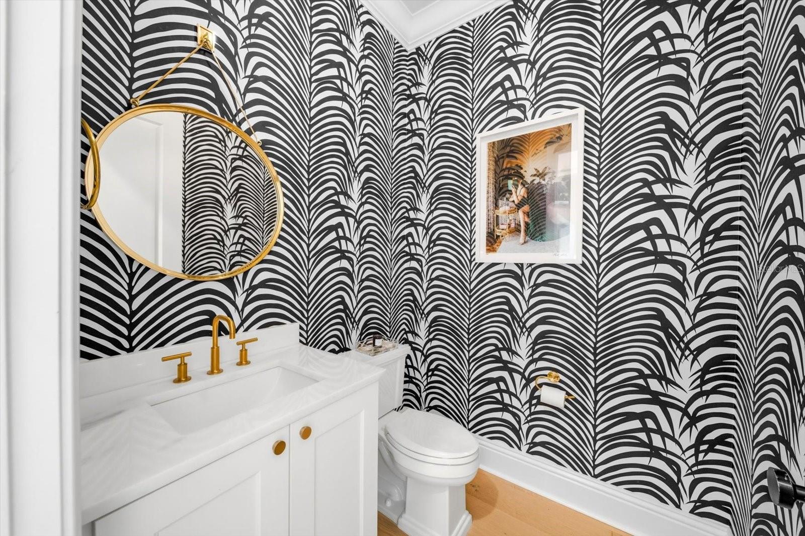 half bath with custom wallpaper - door leading to pool area