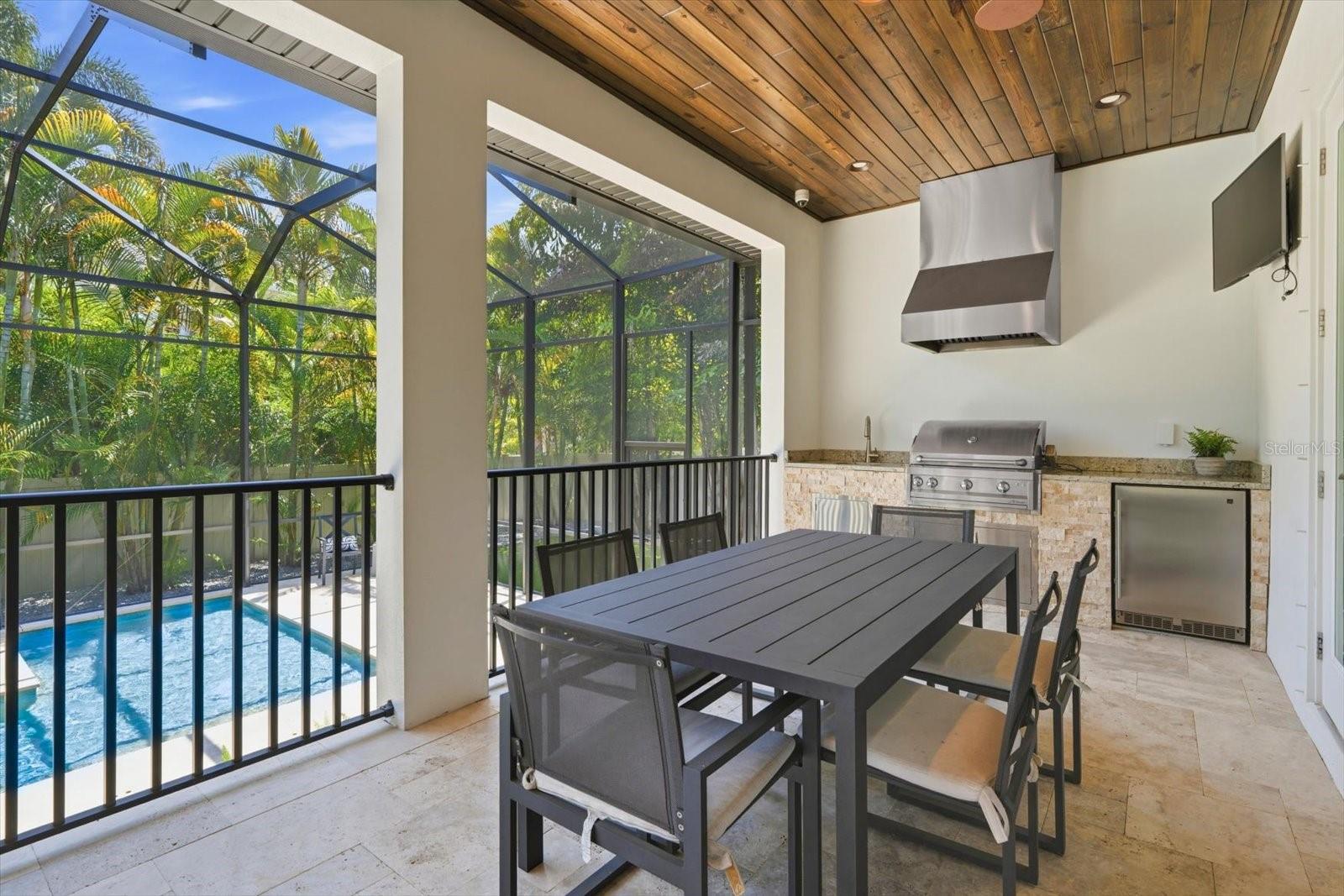 covered lanai with wood ceiling panels - outdoor kitchen