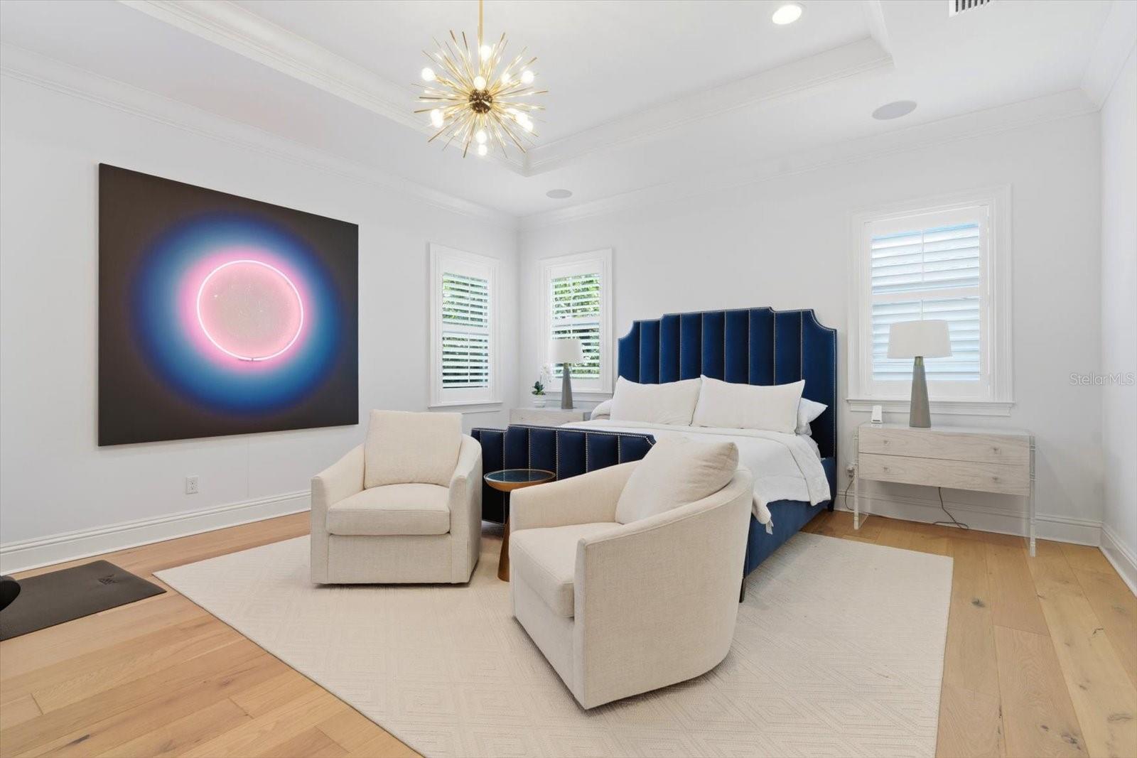 master bedroom with custom chandelier sitting area