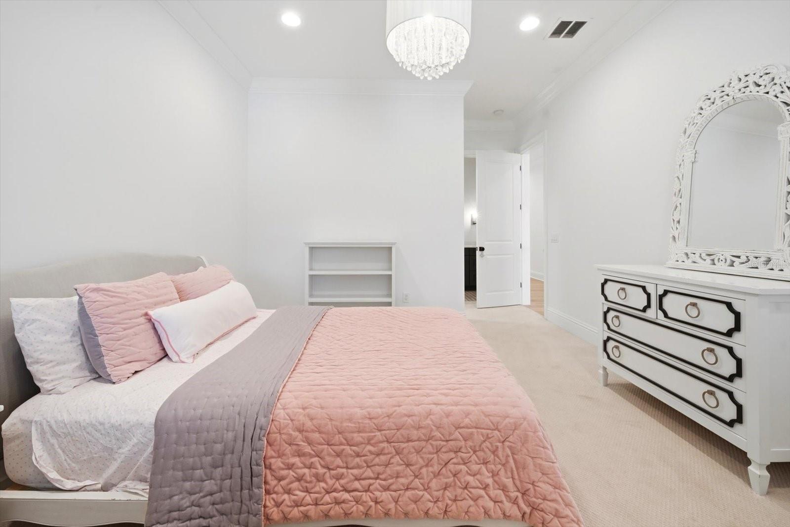 secondary bedroom with custom chandelier