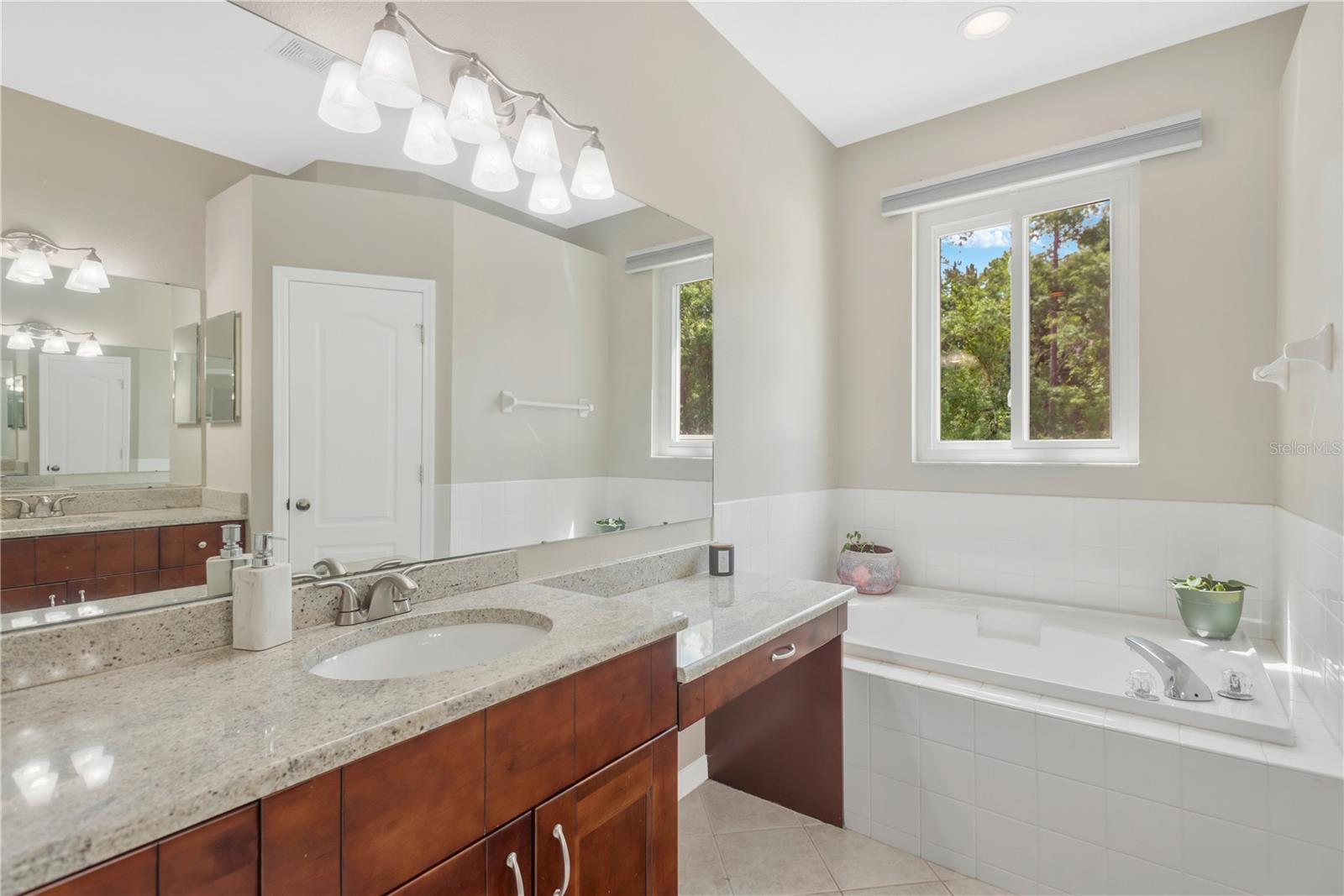 Primary Bathroom showing Vanity, Make-up or Blow Dry Station and Garden Tub