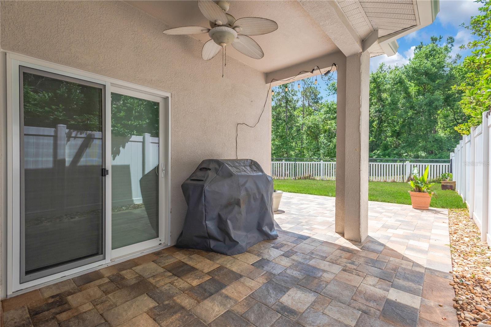 Covered Patio with Pavers and Conservation View - * Lawn has been Digitally Enhanced in this photo