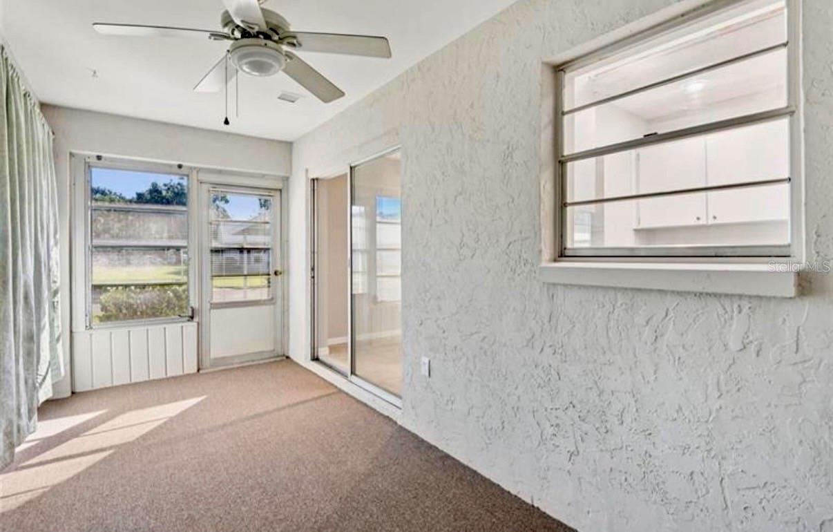 Florida Room with front Exterior Door and AC Vent.