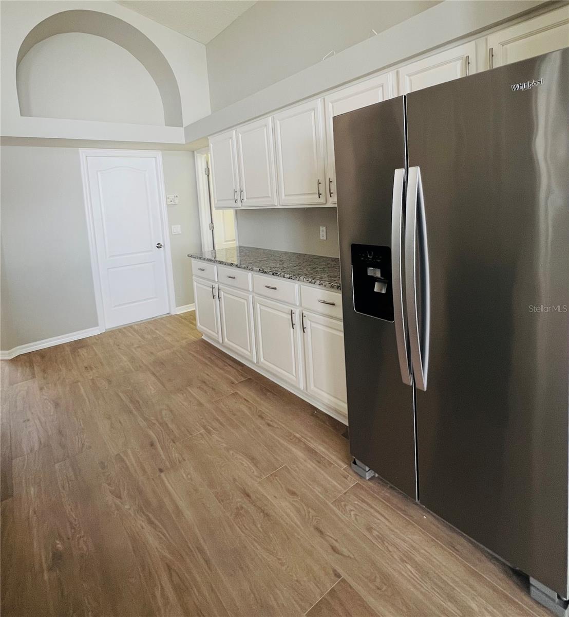 Wood cabinets and stainless steel fridge