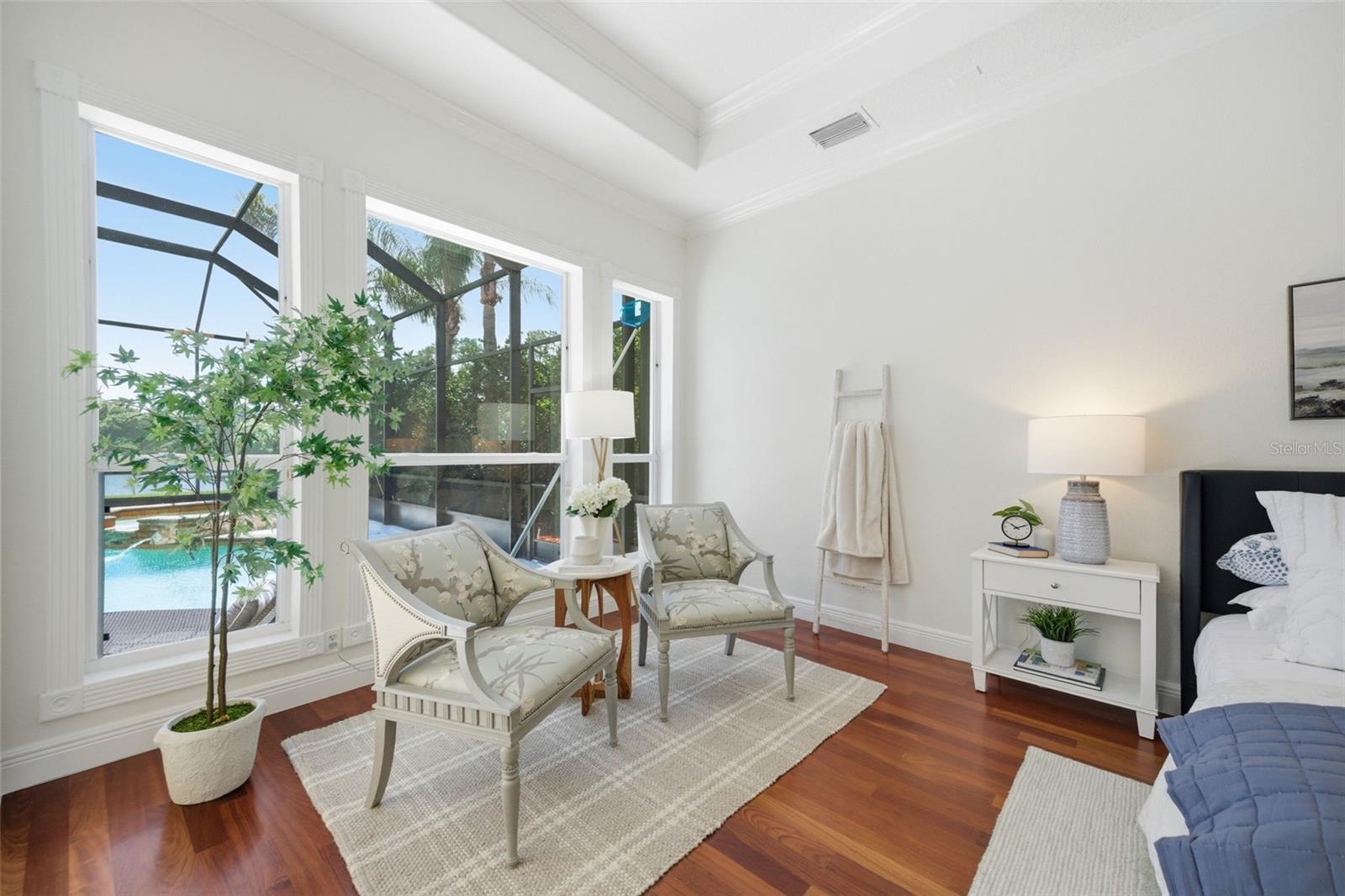 18' x 27' Primary Bedroom with view to pool lanai