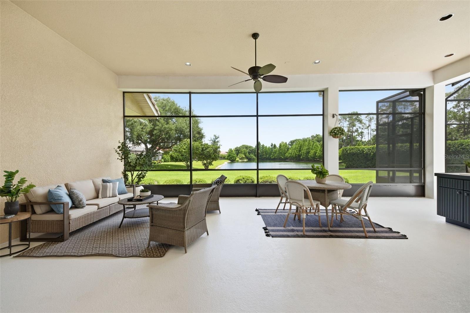 Spacious lanai with outdoor kitchen and pond view