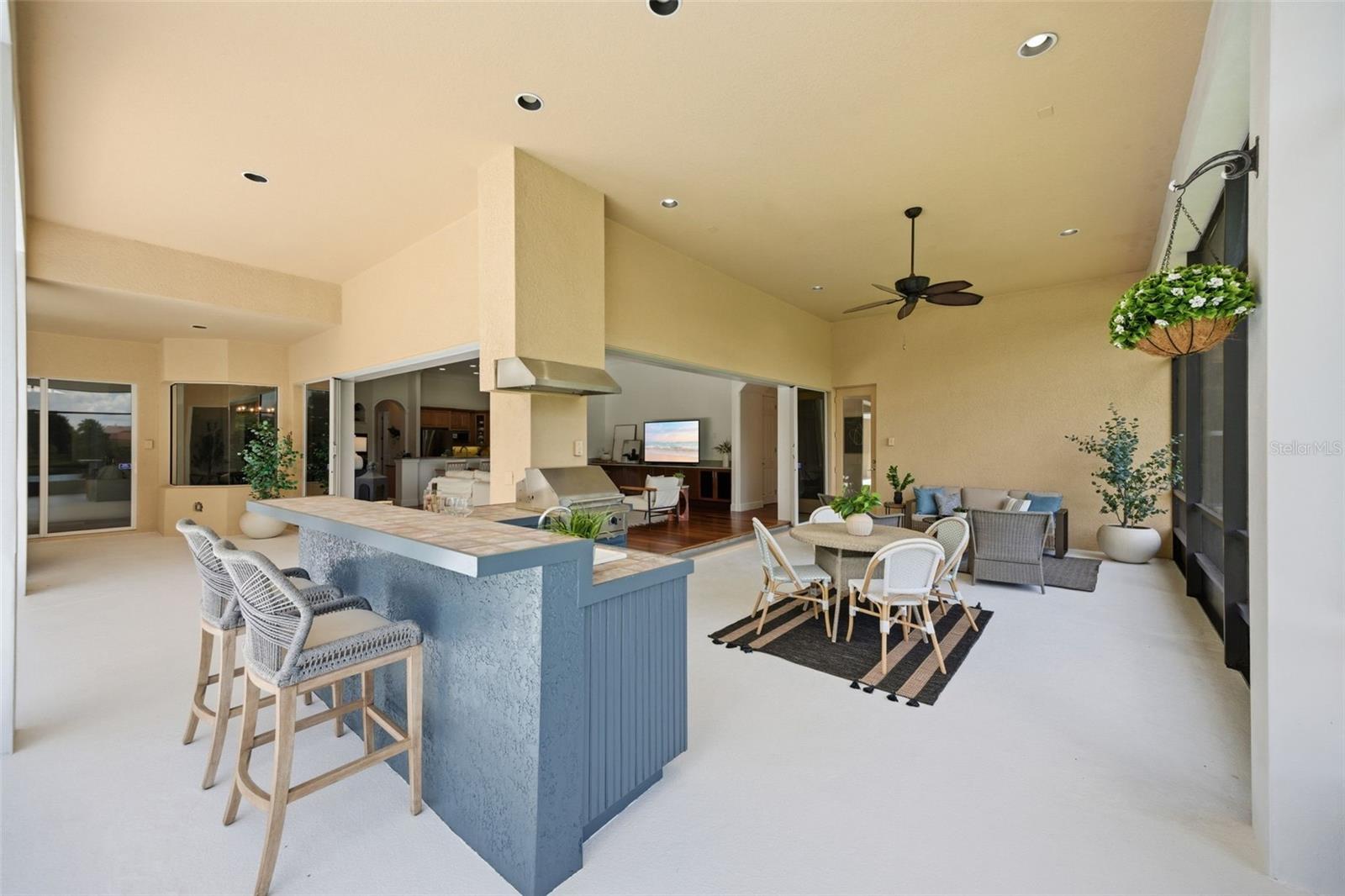 Spacious lanai with outdoor kitchen and pond view