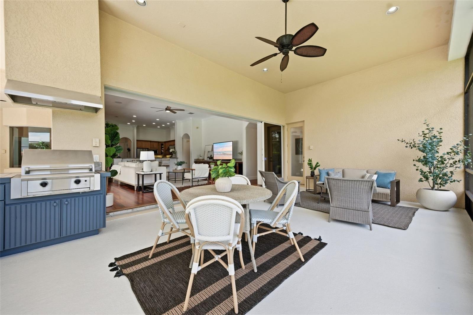 Spacious lanai with outdoor kitchen and pond view