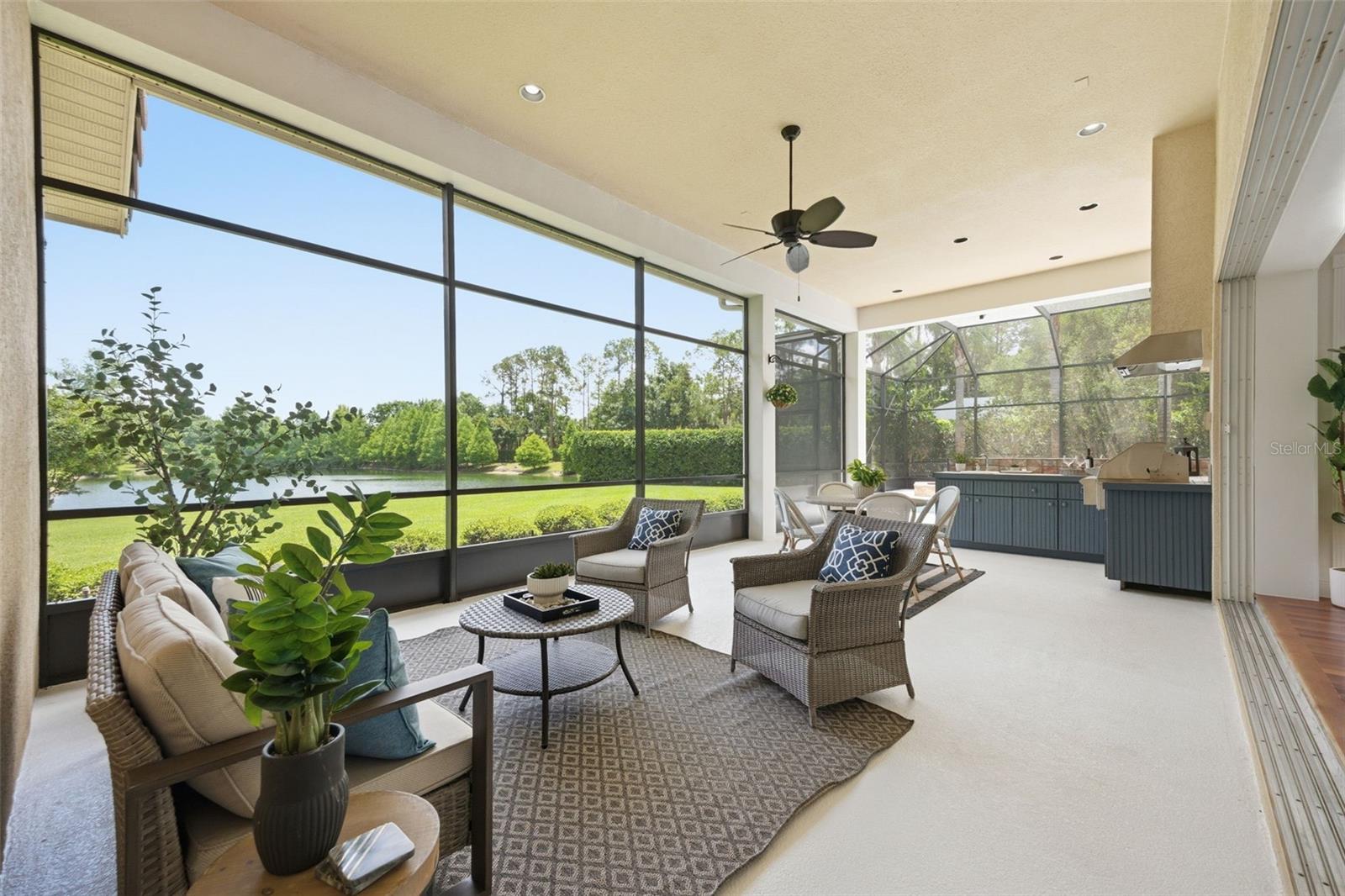 Spacious lanai with outdoor kitchen and pond view