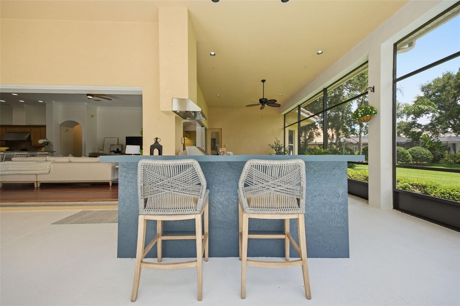 Spacious lanai with outdoor kitchen and pond view