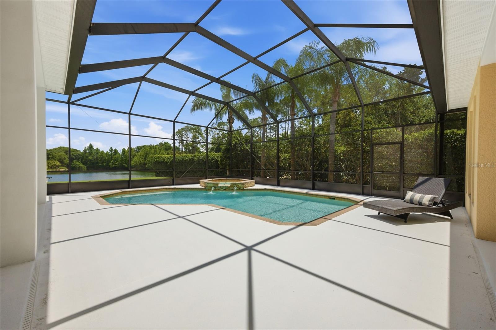 Spacious lanai with outdoor kitchen and pond view