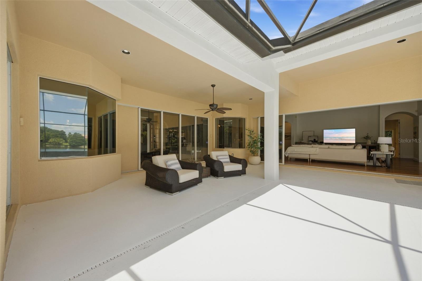 Spacious lanai with outdoor kitchen and pond view