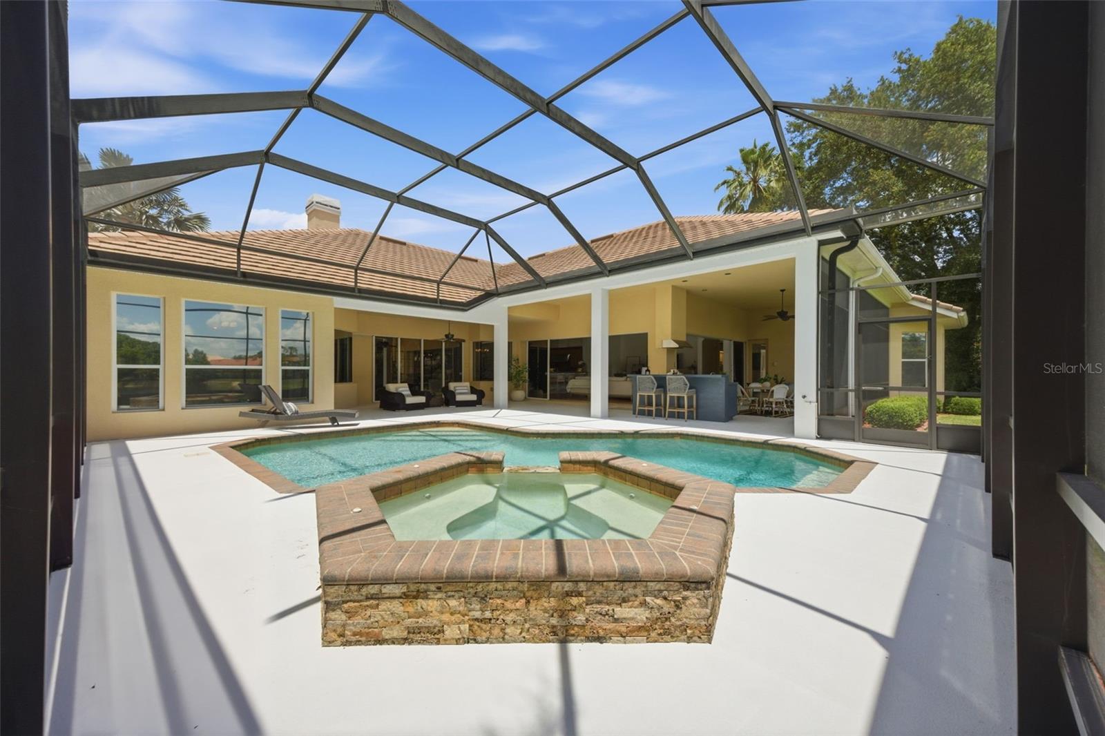 Spacious lanai with outdoor kitchen and pond view