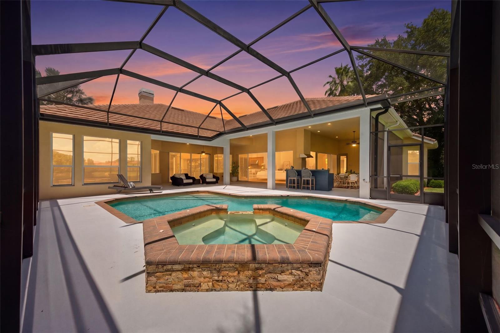 Spacious lanai with outdoor kitchen and pond view