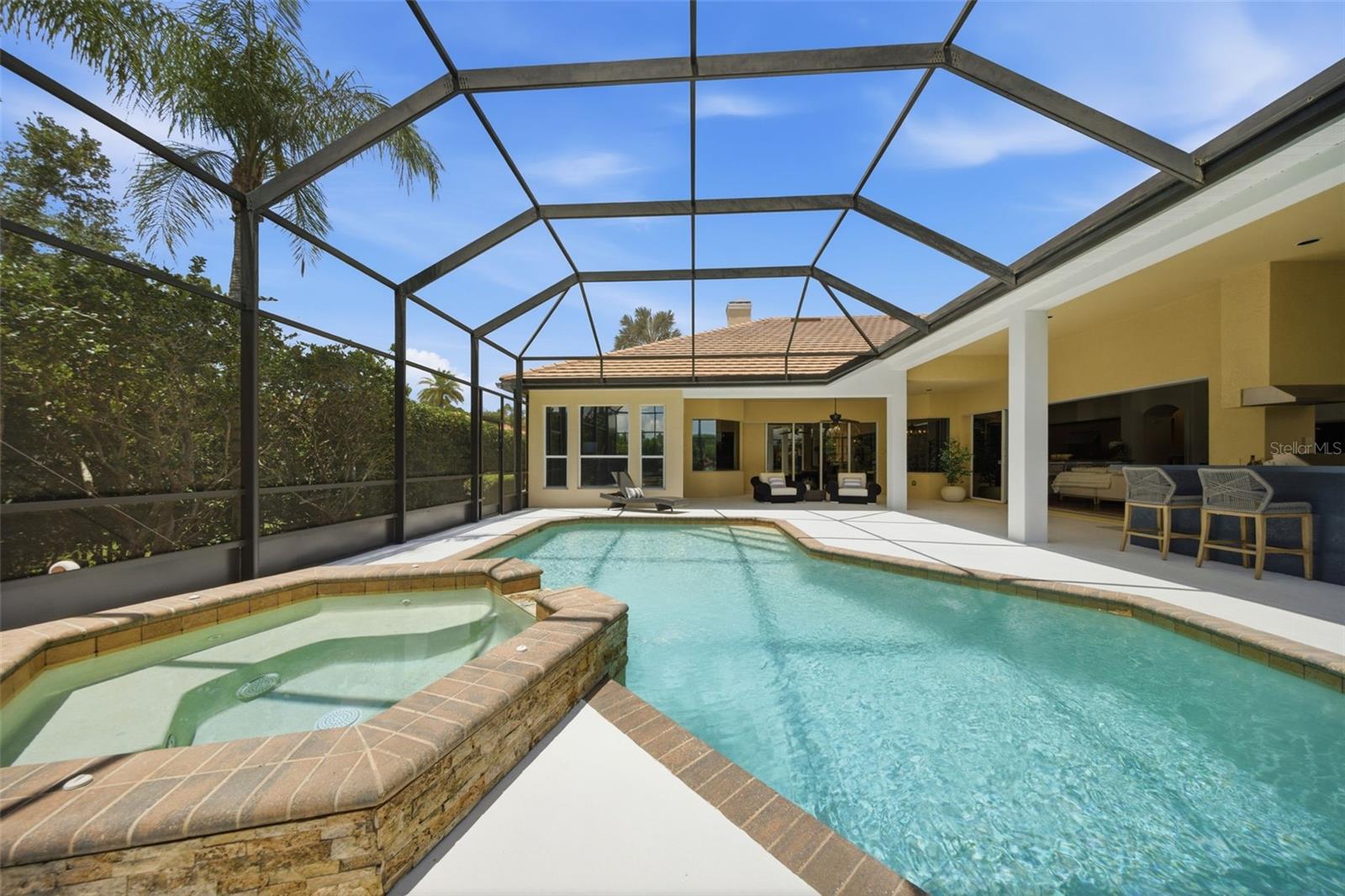 Spacious lanai with outdoor kitchen and pond view
