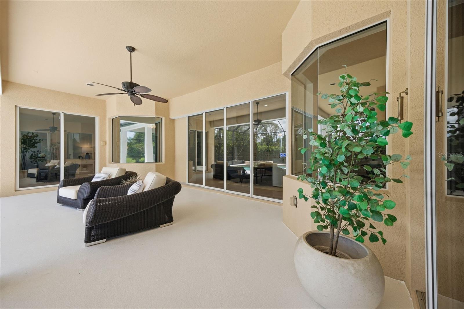 Spacious lanai with outdoor kitchen and pond view