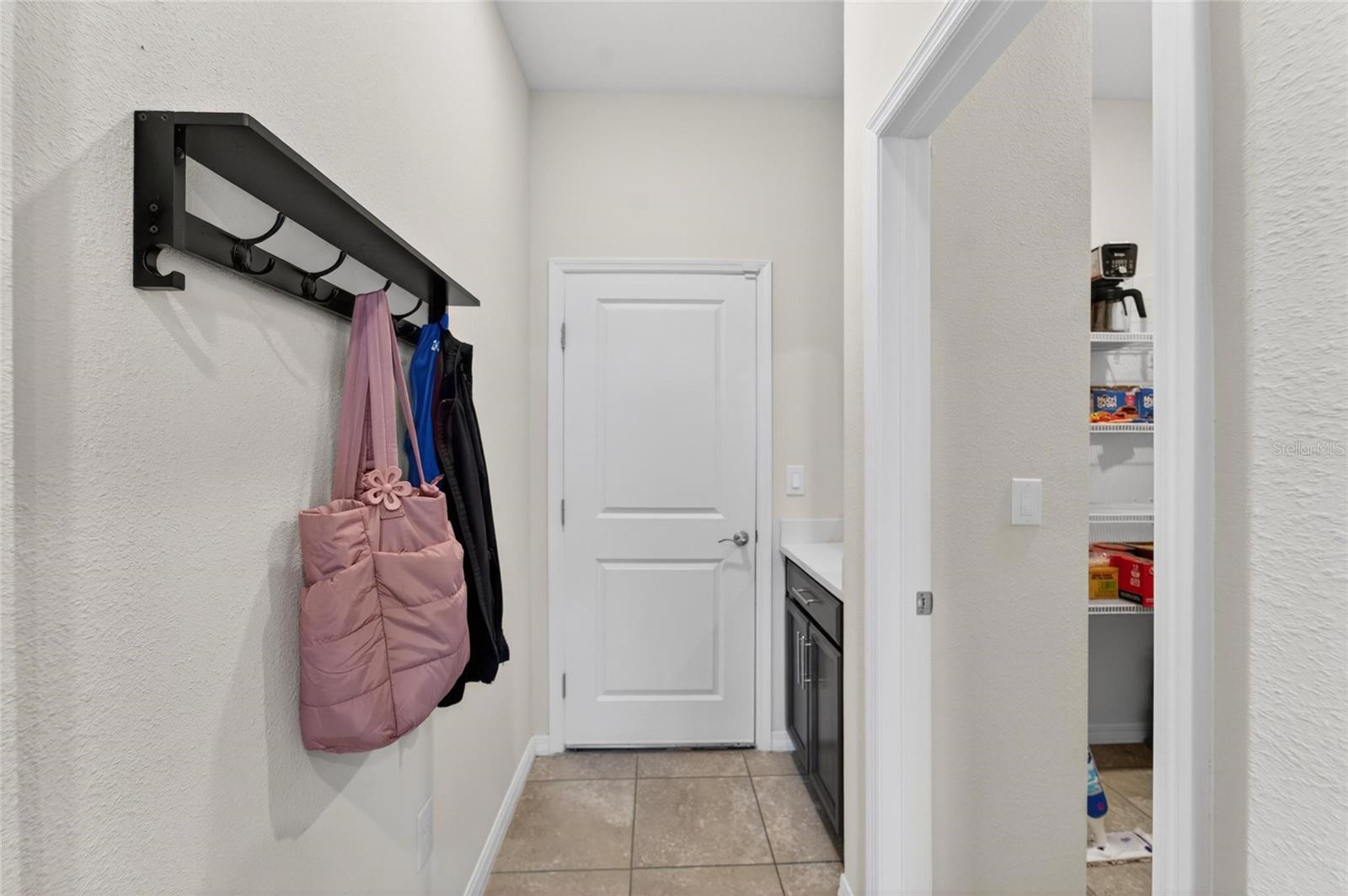 Hallway from the garage that leads to the kitchen area.