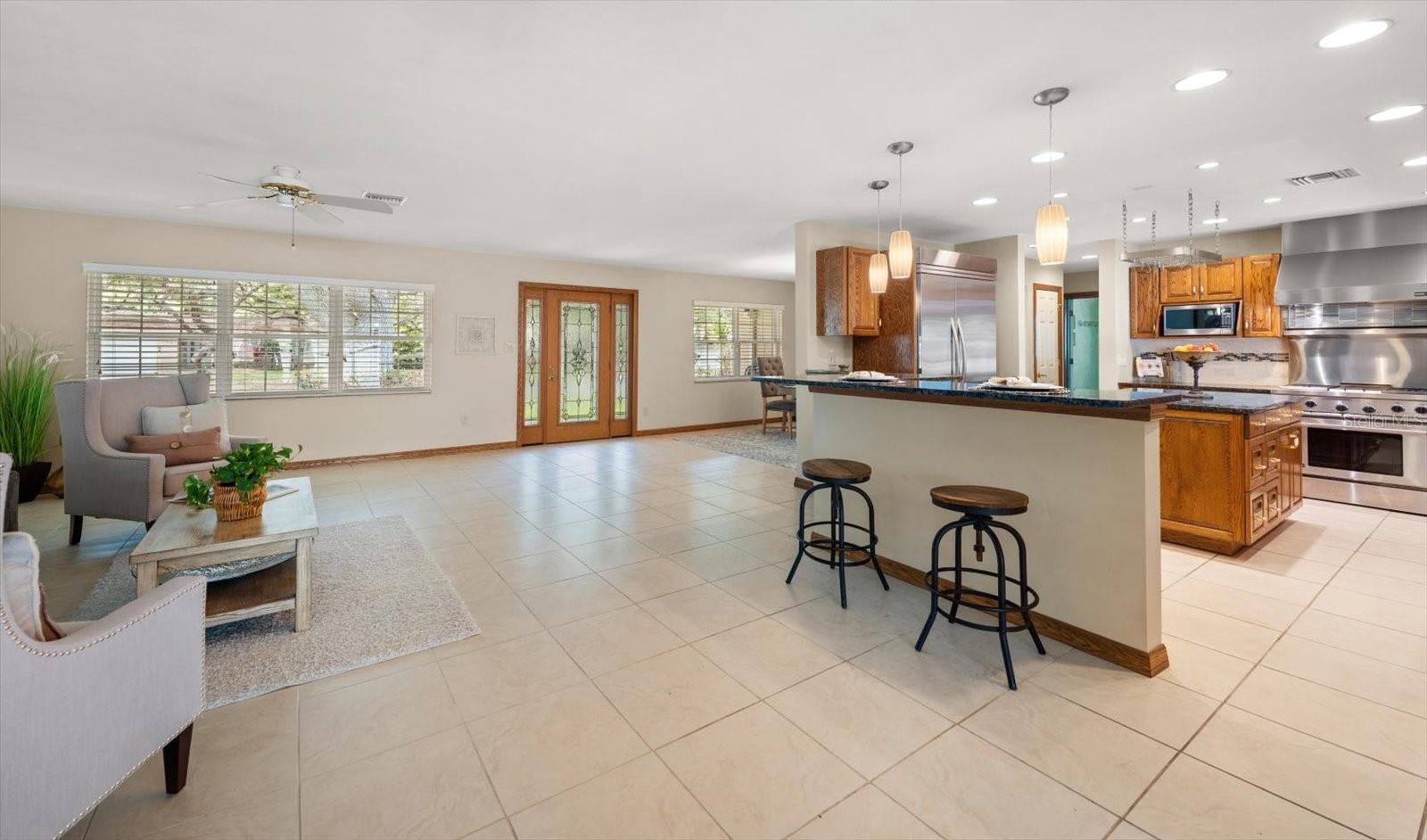 Illuminated living spaces create the ideal setting for gathering and entertaining from the formal dining and living areas that seamlessly flow into the kitchen and great room.