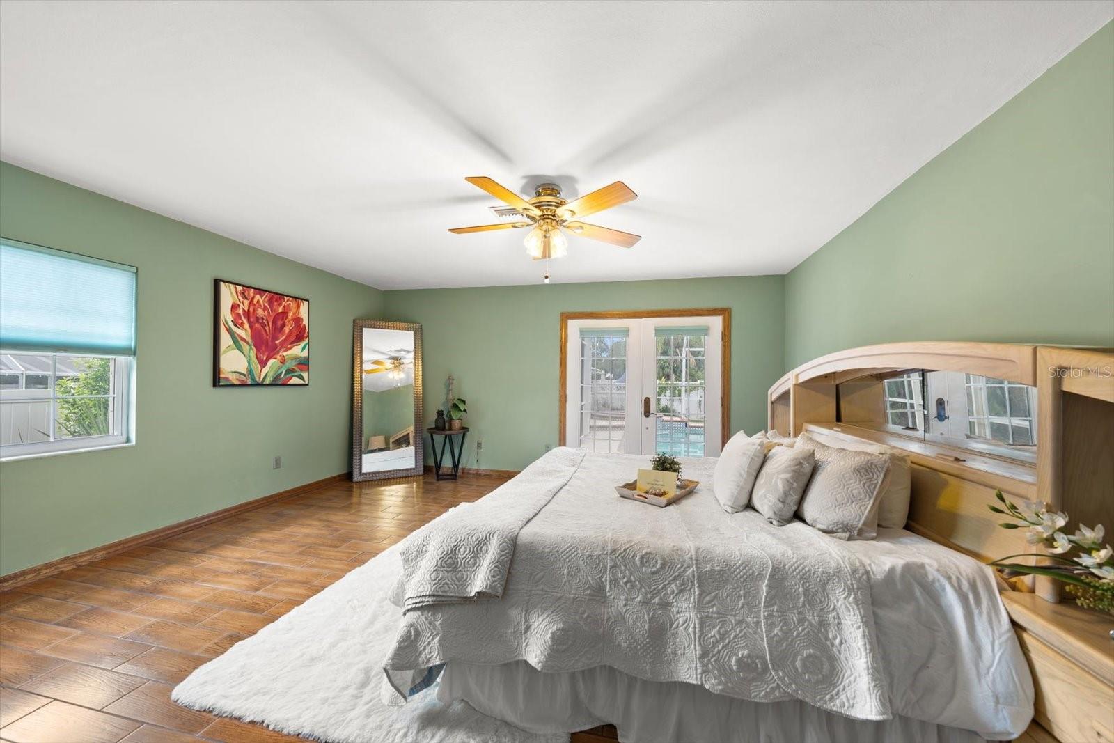 The primary bedroom provides private access to the pool area and an ensuite bathroom.