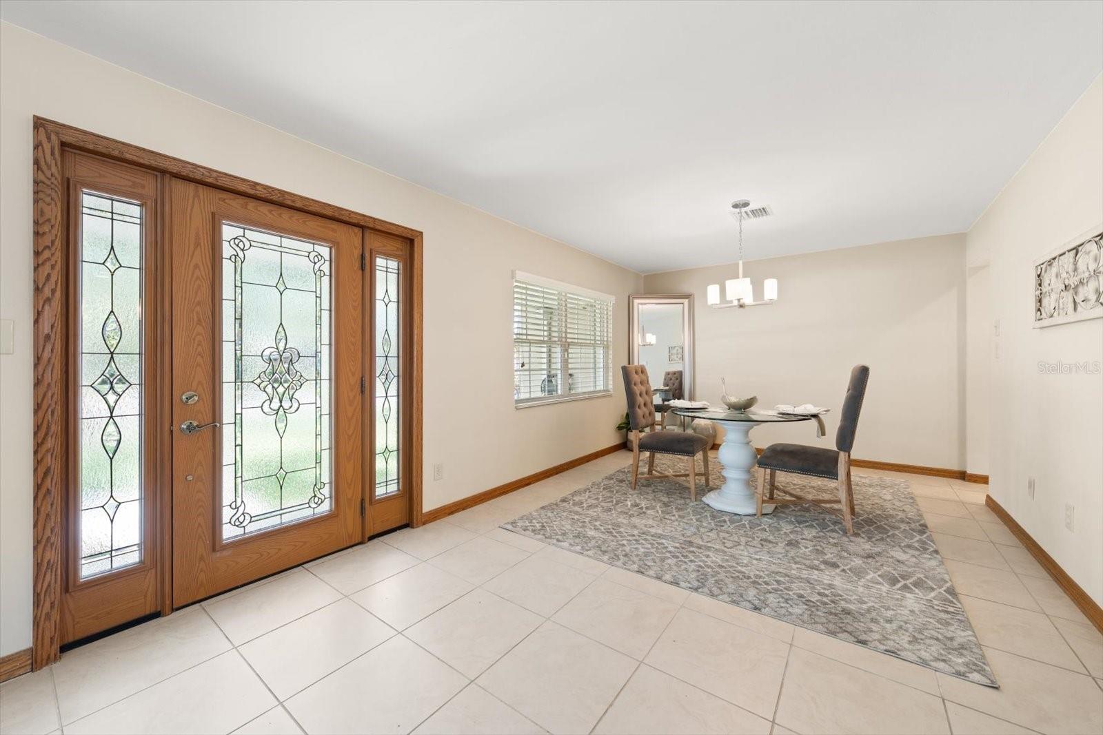 Exquisite finishes found throughout the home include decorative beveled glass entry door and porcelain flooring.