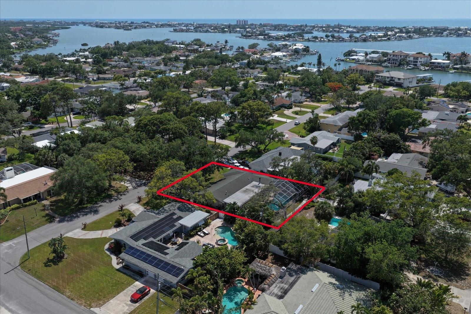This property offers a generously sized lot with a large screened pool area and backyard space.
