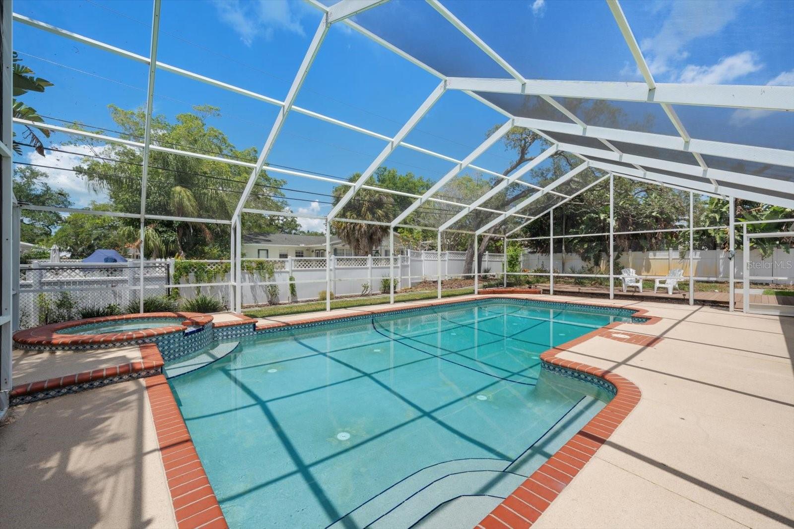 Private spa, pool, and lounge areas create an idyllic outdoor living space, perfect for entertaining or relaxing on warm sunny days!