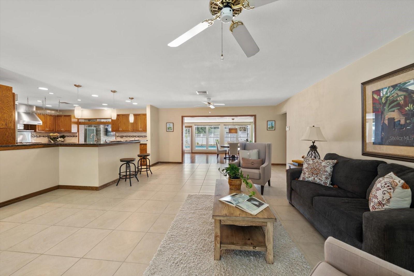A spacious and inviting living area flows effortlessly into the open-concept kitchen and rear great room, creating a seamless layout ideal for both everyday living and entertaining.