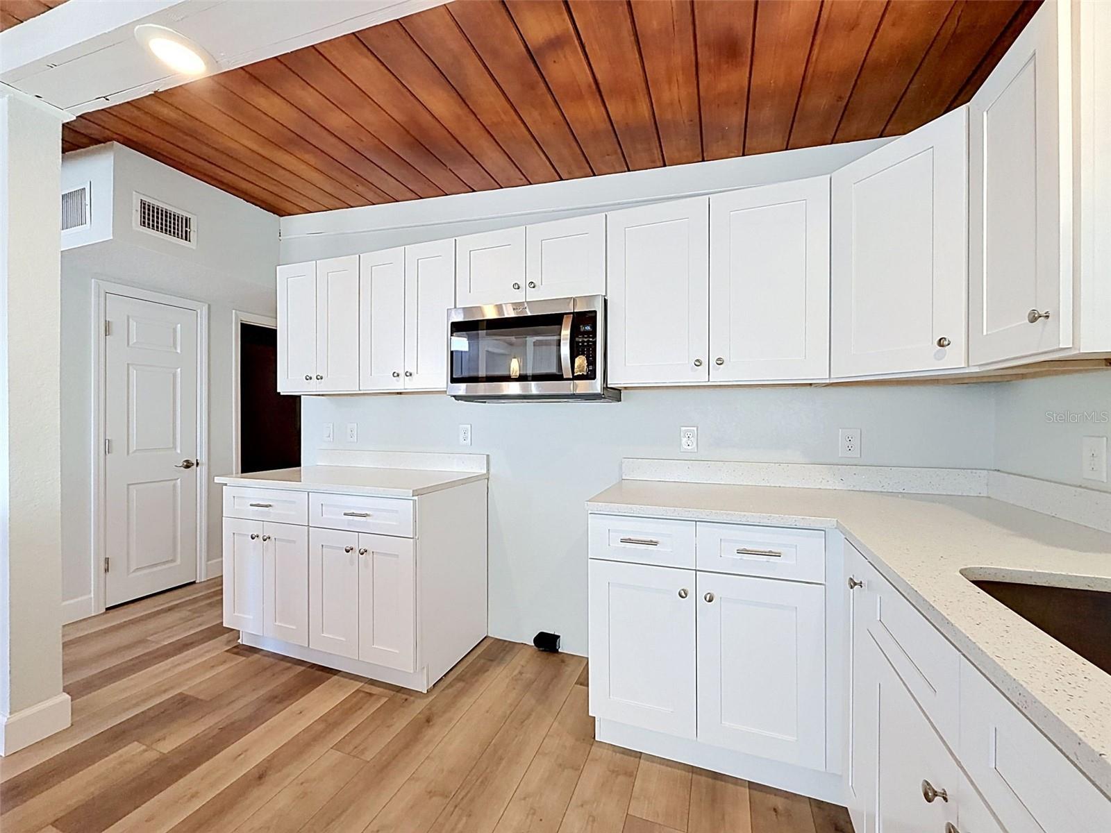 “Coastal-modern finishes complement the home’s unique architectural ceiling design.”
