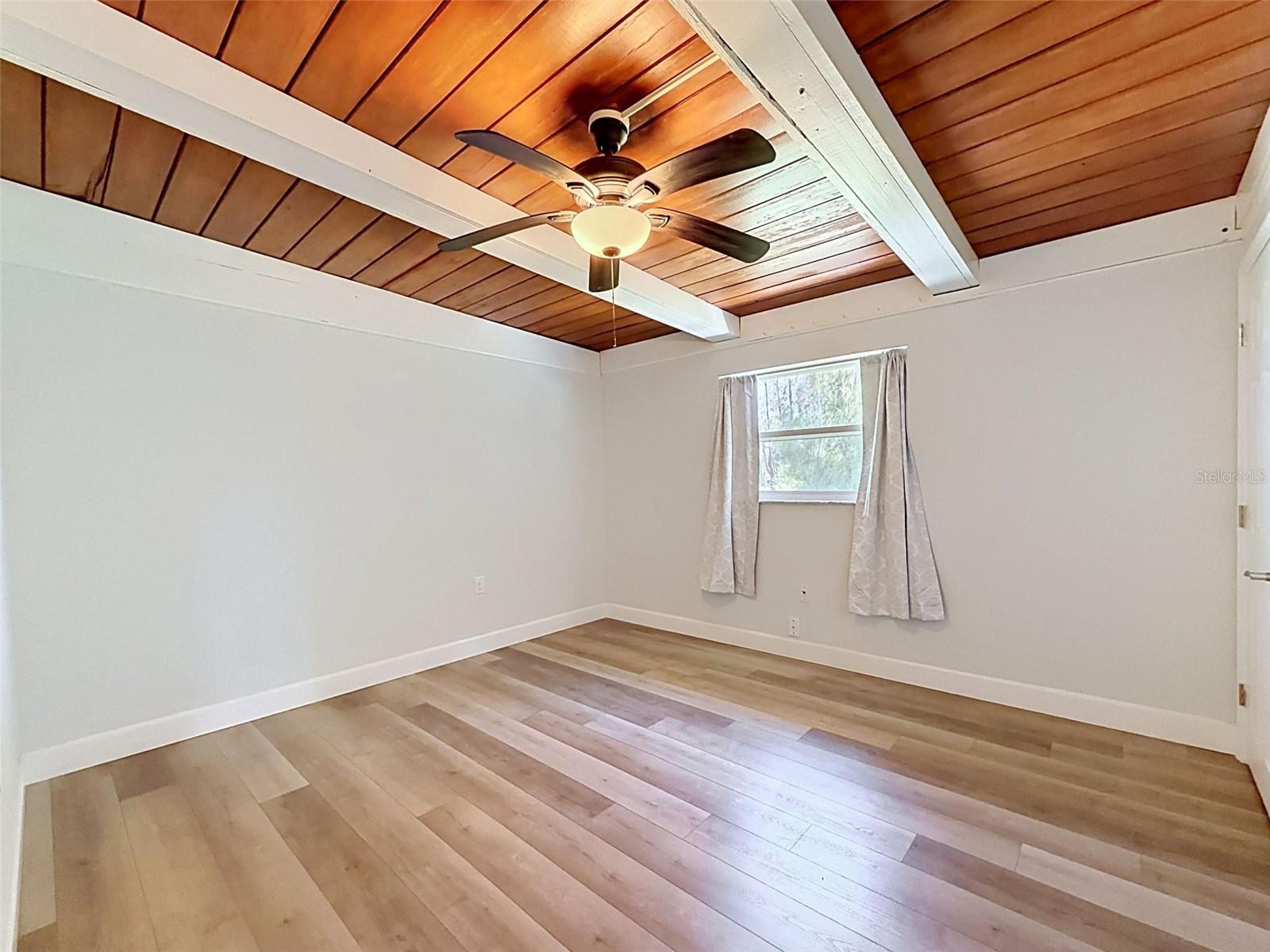 • Roomy secondary bedroom with plenty of wall space and natural light for a relaxing retreat.